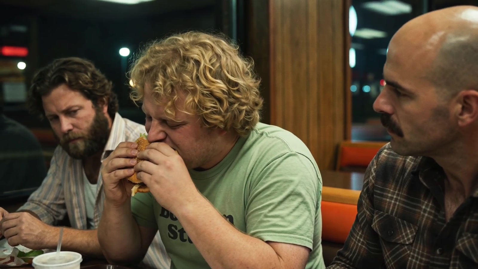 The three men eating at a table