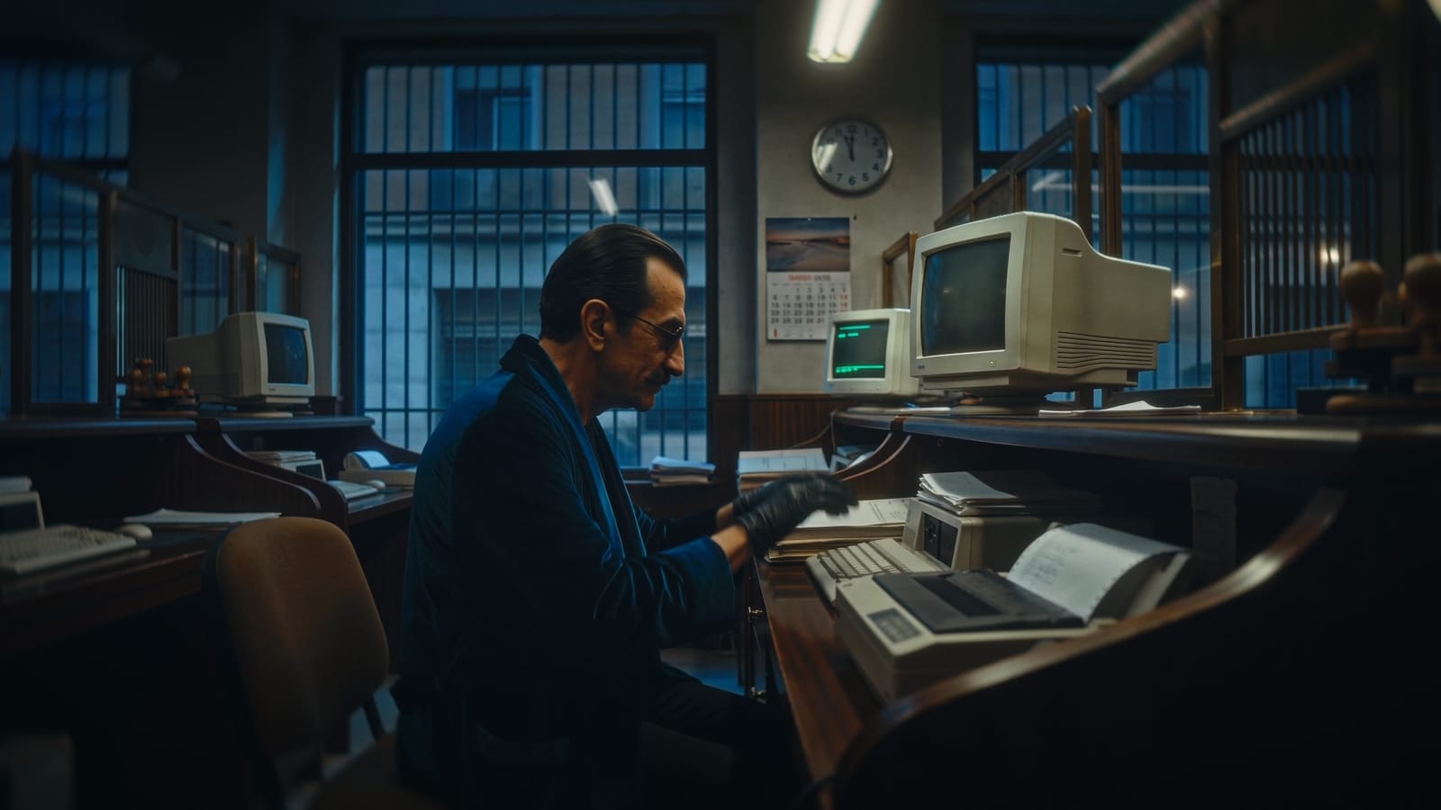 José at a bank terminal at night, wearing gloves